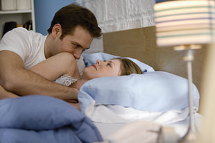 man and woman sleeping on bed