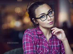 woman wearing eyeglasses with black frames and pink dress shirt