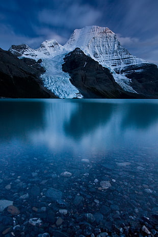 calm shallow water under snow covered mountain, mount robson