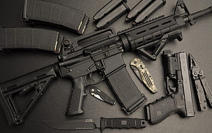 black rifle, pistol, knife, and magazines