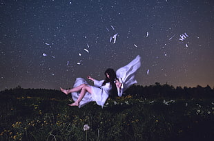 photo of woman in white dress during night time