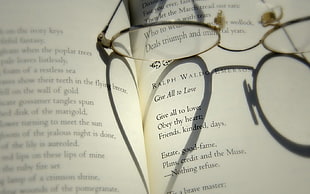 eyeglasses on top of book HD wallpaper