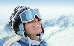 shallow focus photography of person in teal beanie and ski goggles