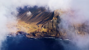 aerial photo of mountain near sea HD wallpaper