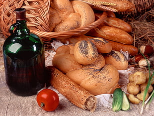 variety of bread near green glass carboy