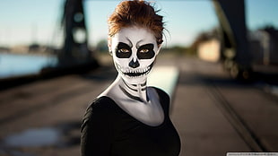 shallow focus photography of woman with skull face paint