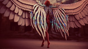 shallow focus photography of woman with wings