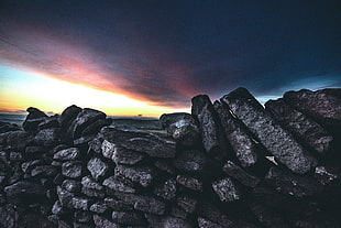 pile of grey bricks at sunset