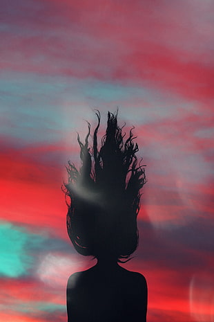silhouette of woman with red, blue, and purple backround