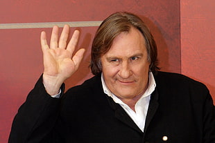 man in black sweater waving his hand