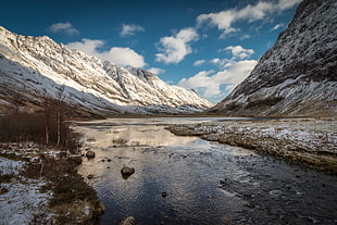 landscape photo of river between snow covered mountains, glencoe