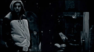 greyscale photo of man wearing grey hoodie