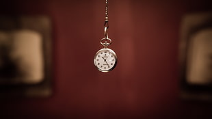 round silver-colored framed analog locket watch