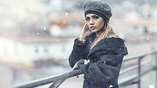 woman wearing gray knit cap and black paraka