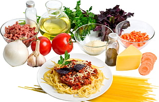 spaghetti on white ceramic plate , cheese , bowls and vegetable