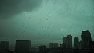 high rise buildings, cityscape, rain, dark