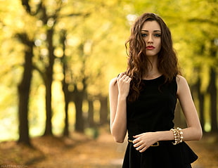 selective focus photo of woman wearing black sleeveless dress