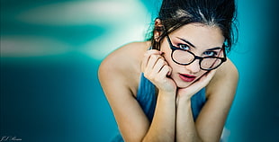 woman wearing clear eyeglasses with black frame