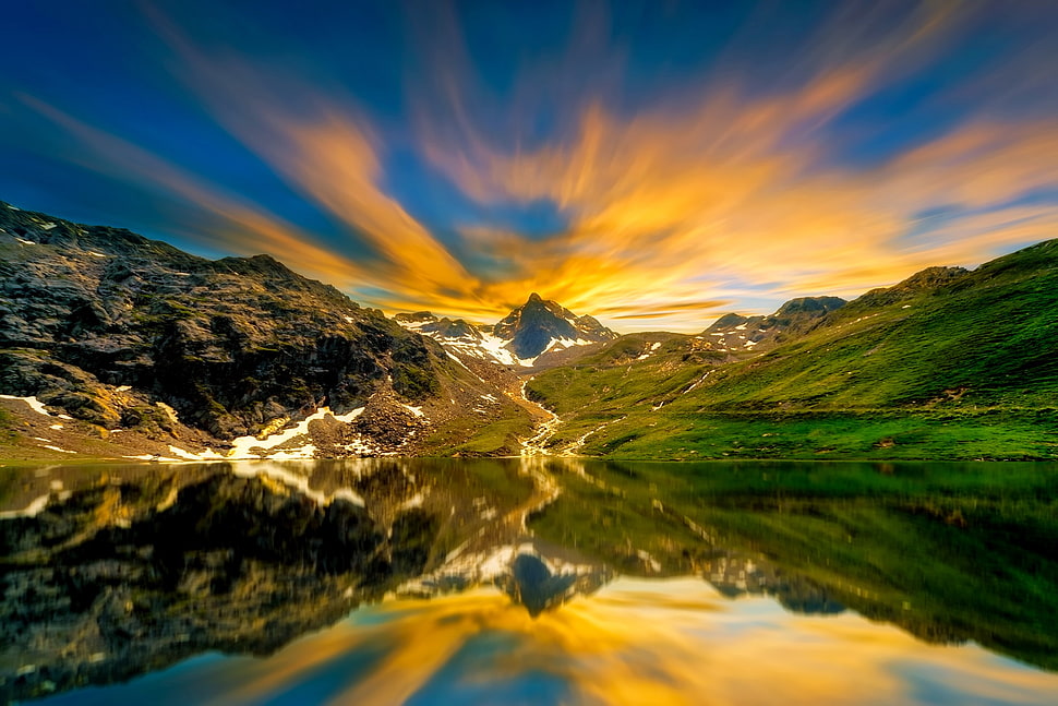 mountains and green grass during daytime HD wallpaper