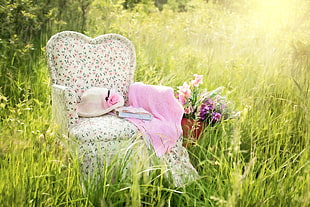 white and pink armchair  and flowers