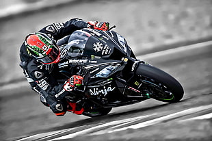 person riding black black Kawasaki Ninja sports bike during daytime HD wallpaper