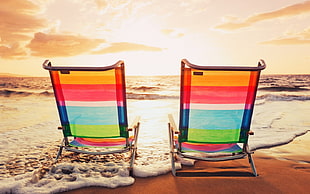two multicolored beach loungers on beach at golden our