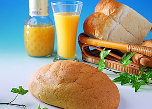 bread beside juice-filled glass, and pitcher