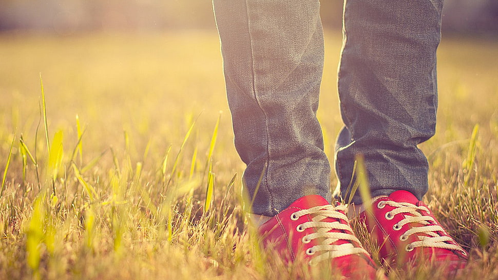 close photography person's blue denim pants and red sneakers HD wallpaper