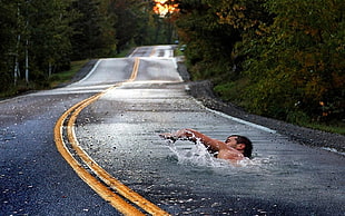 man swimming in pave road illusion photo, swimming, photo manipulation, road HD wallpaper