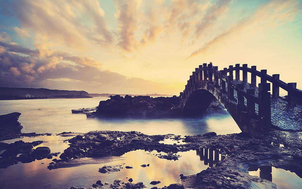 black concrete bridge under cloudy sky HD wallpaper