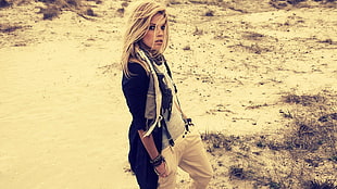 woman in black and cardigan and white jeans in desert