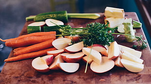 closeup photo of sliced apples, carrots, and cucumbers