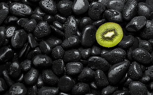 black and yellow plastic balls, kiwi (fruit), water drops, stones, fruit