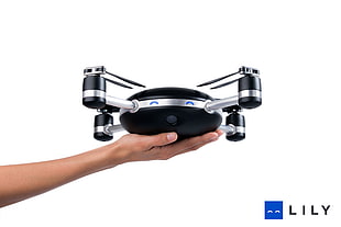 person holding black and gray drone