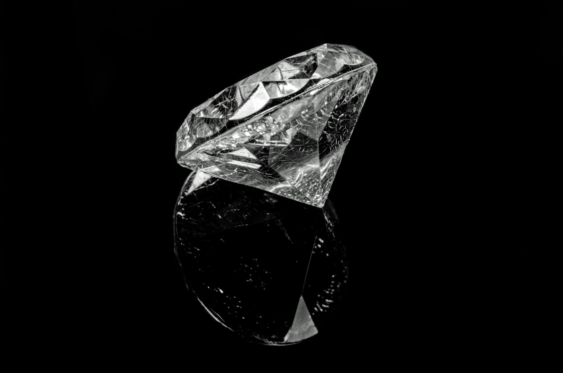 diamond gemstone on black surface