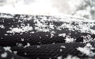 black textile with snow flakes