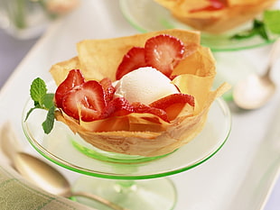 strawberry desert on green glass saucer