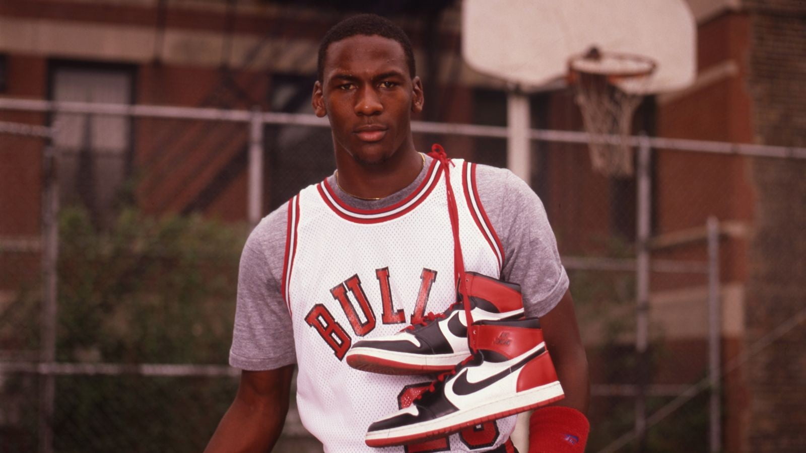 Man In White And Red Chicago Bulls Jersey Shirt With Pair Of White-And-Red  Air Jordan 1 Shoes On Hanging On Shoulder Hd Wallpaper | Wallpaper Flare