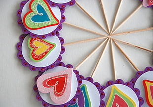 purple, white, and pink heart floral lollipop sticks form of round