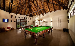 billiard pool table near white wall