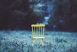 beige wooden chair on green grass fields