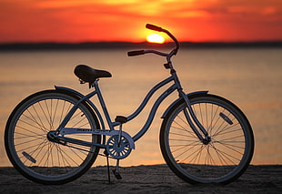 white frame beach cruiser bicycle during sunset