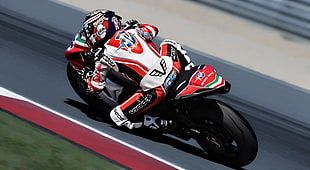 photo of man riding on black and red sports bike HD wallpaper