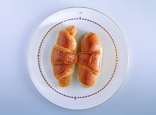 two baked bread on white ceramic plates