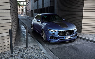blue and black Maserati sedan on gray concrete road