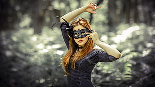 woman in black elbow-sleeved shirt wearing black masquerade mask