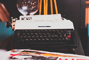 macro shot photography of white and black typewriter on table