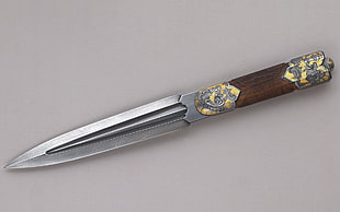 brown wooden handle silver dagger