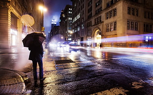 men's black coat, rain, umbrella, long exposure, city