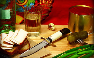 white and black handled knife on brown wooden table